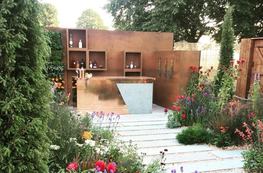 Path of plank paving and gravel leads to Garden Bar with Grey Yorkstone detail.