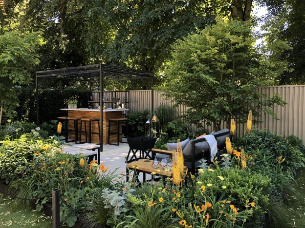 Jura Beige Limestone paves The Landform Garden Bar at RHS Hampton Court 2018. Stools at counter in background.