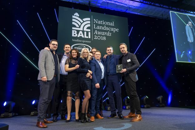 9 members of staff pose for picture at BALI awards 2018, holding award partially won by London Stone reviews on Trustpilot.