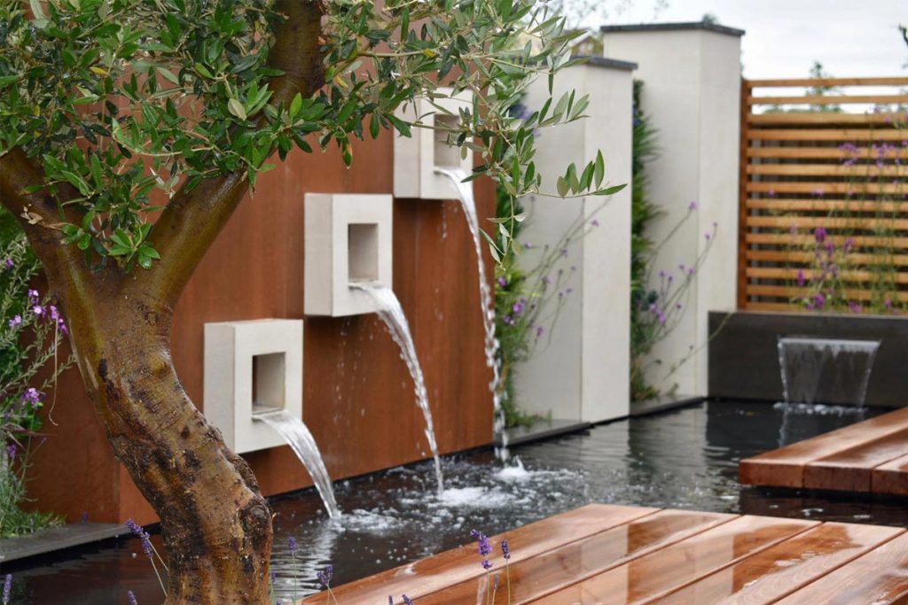 Water pours from the DesignClad wall cladding to create a stunning water feature.