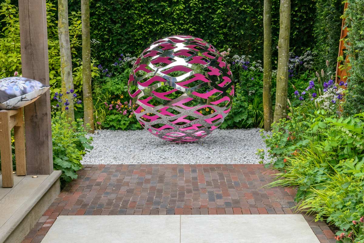 Abbey Dark Multi Clay Pavers with Silver Grey Porcelain and large metal sculpture on David Harber trade stand RHS Chelsea 2016