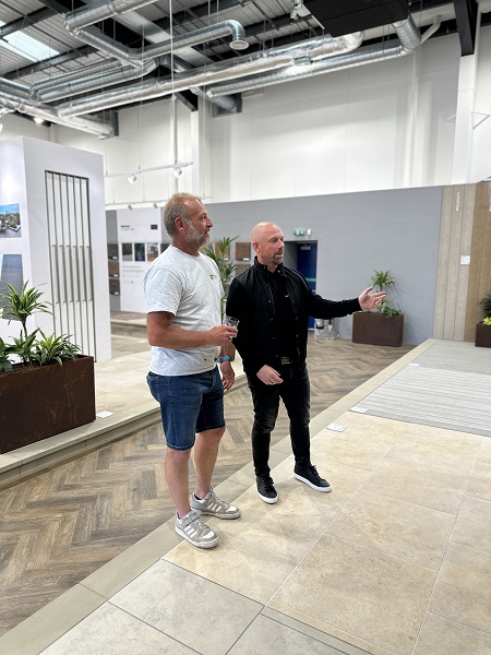 Jamie Norris explains materials to landscaper in Hampshire showroom.