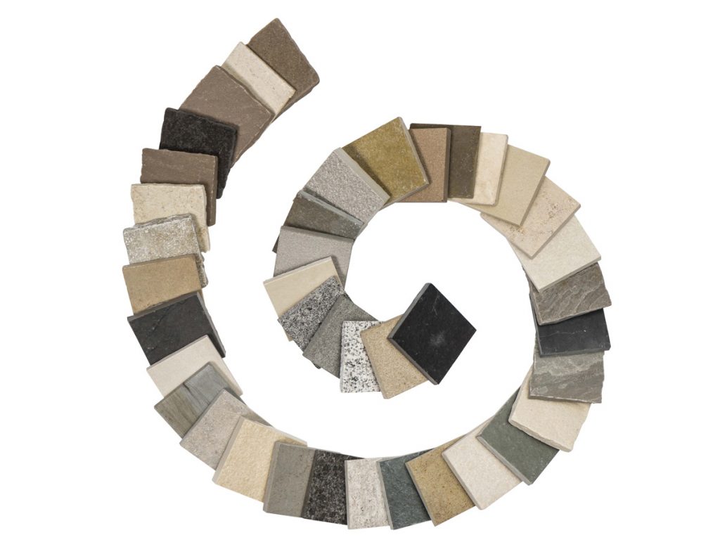 Spiral of small square paving samples in different colours and textures.