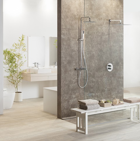 DesignBoard Vulcano Ceniza porcelain shower wall creates room divider with sink beyond
