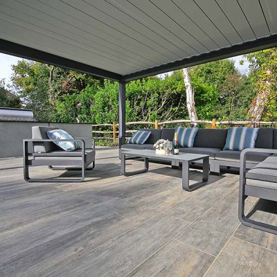 Grey Wood Effect Porcelain Tiles under a metal pergola with grey metal garden furniture.