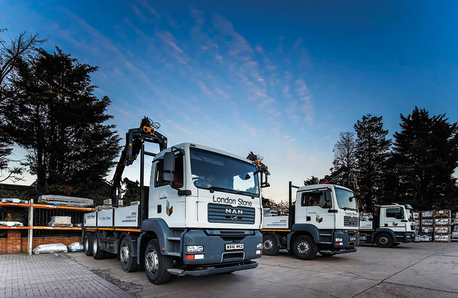 2 HIAB lorries parked on hard standing, blue sky above, 