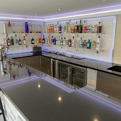 Home bar with, bottles and counter, rear walls of Desert Beige DesignClad cladding for interior walls.