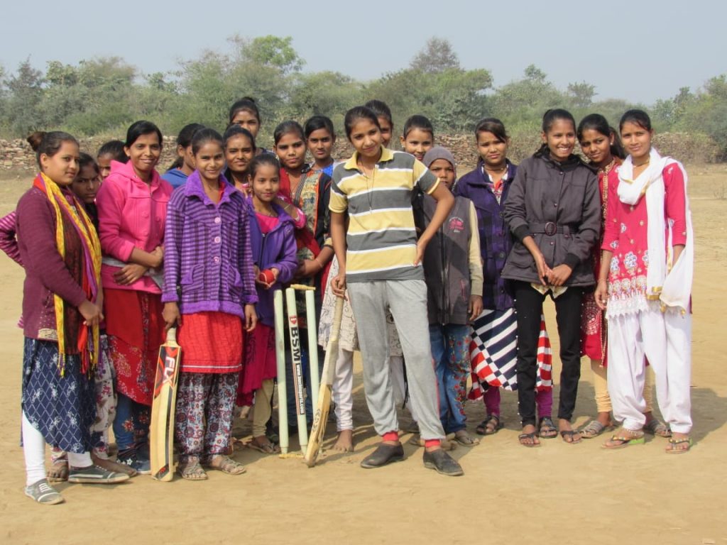 A girls' cricket team posing for the camera, in Budhpura, Rajasthan, India, No Child Left Behind