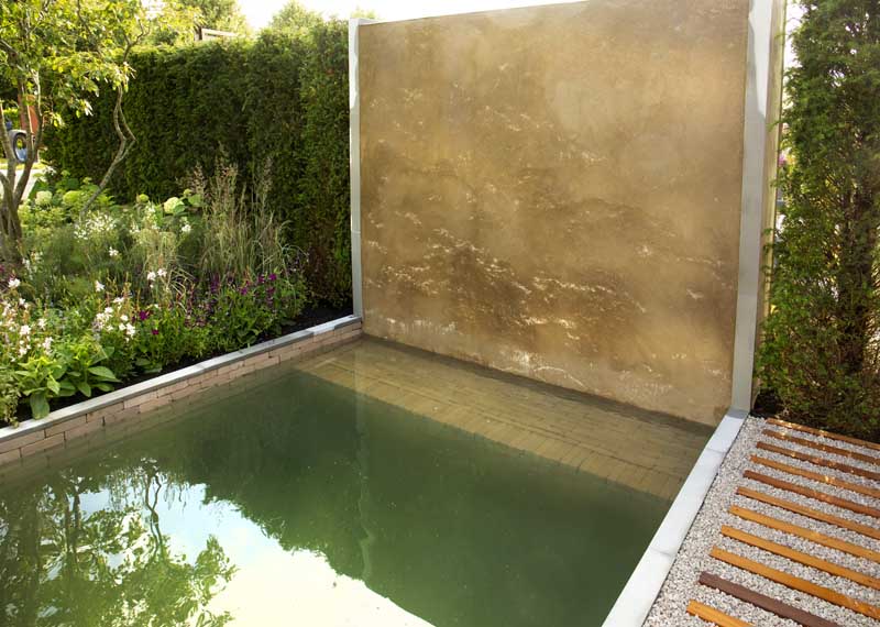 Clay pavers and limestone make a stunning backdrop in this water feature. 