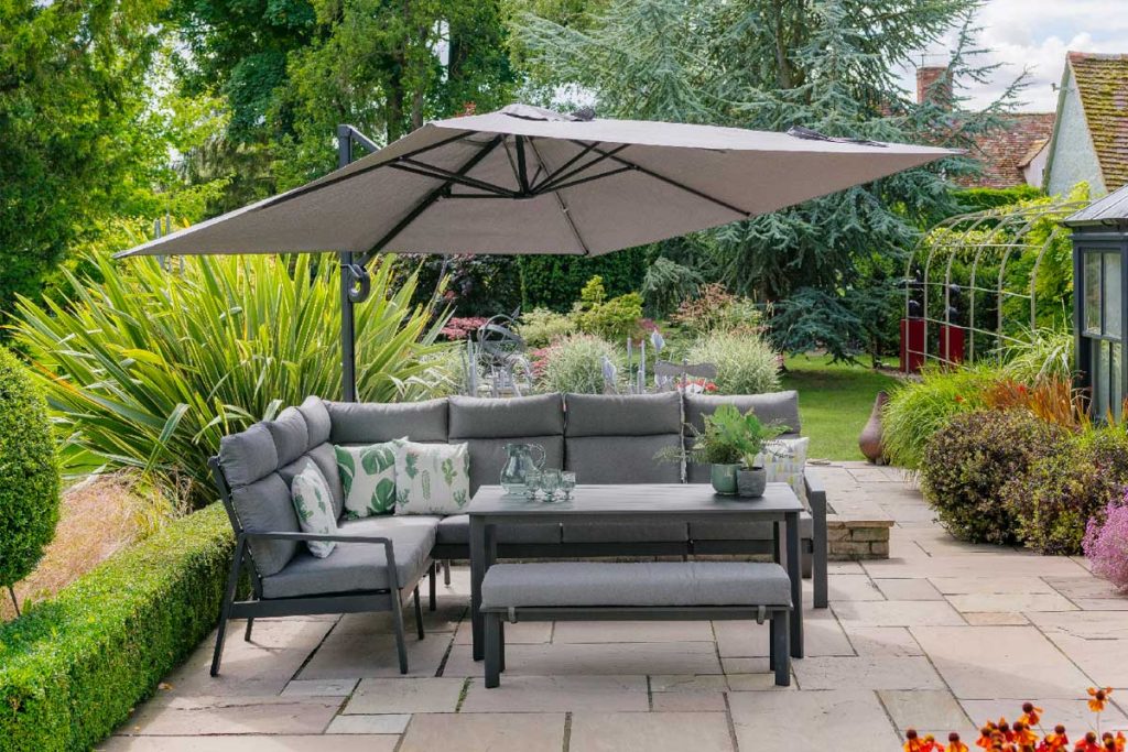 Our Santorini Square Cantilever Parasol in dusk makes a practical and stylish addition to the garden. Sitting over this modular garden set it provides shelter from rain and shine. 