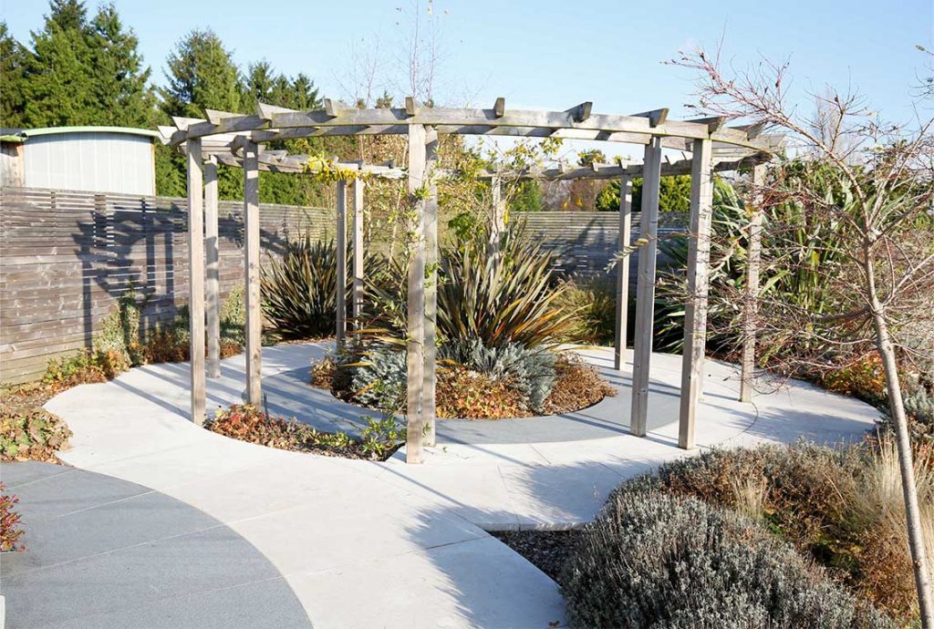 A round pergola with porcelain paving laid in circles in and around it at London Stone's showroom, Cooling's, Knockholt Kent