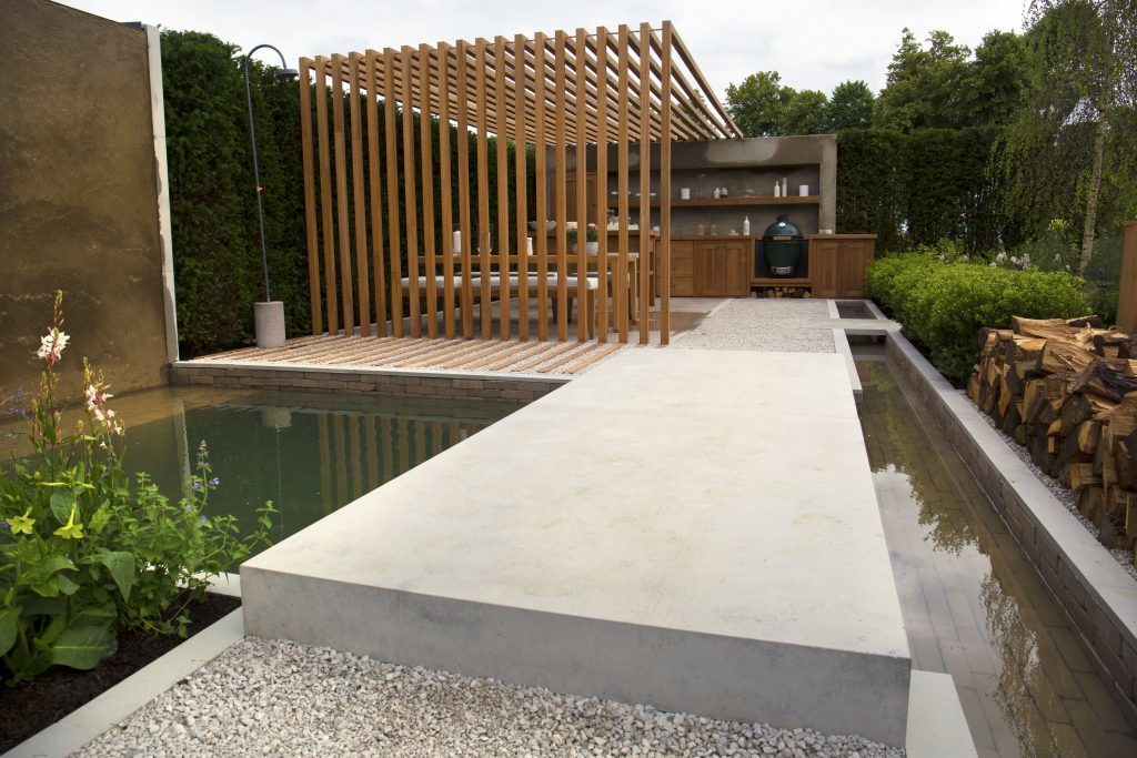Large slabs of Jura Beige Limestone create a bridge over a waterfall and plunge pool feature.