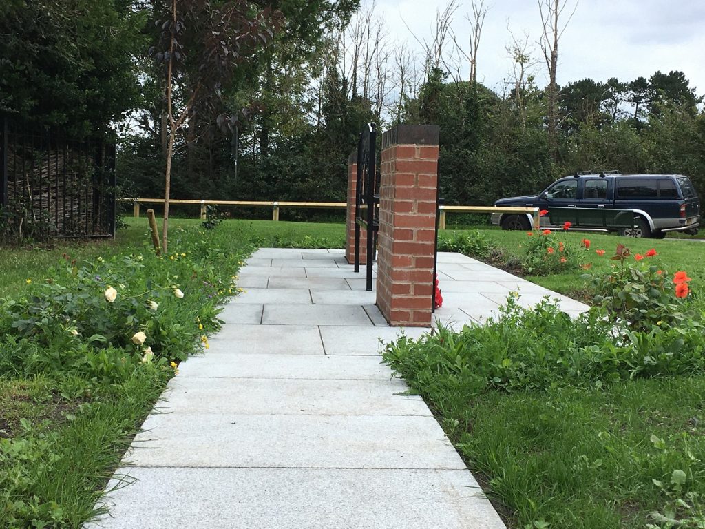 View of Sandway and Cuddington War Memorial from side showing Silver-grey granite paving.