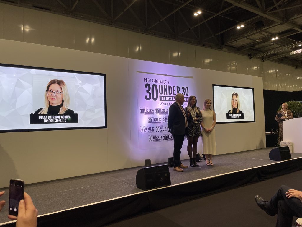 Diana on stage accepting her Pro Landscape 30 Under 30 award at the FutureScape ceremony.