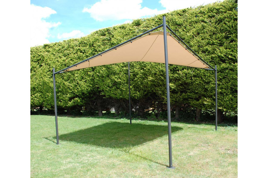 Our 3.5m cream shade sail sits on the lawn, in front of a high hedge, providing shade for the garden.
