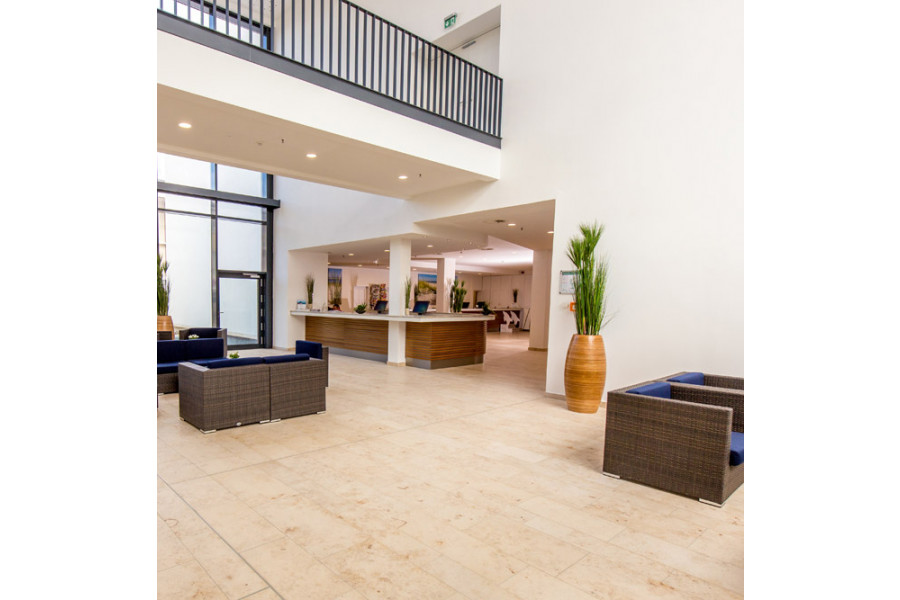 Our Jura Beige Honed Limestone indoor Tiles are used in this commercial space for an elegant entrance.