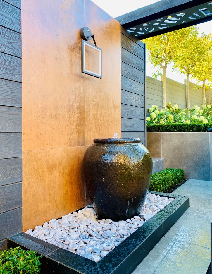 Luxury DesignClad is used to create a feature wall behind this water feature.