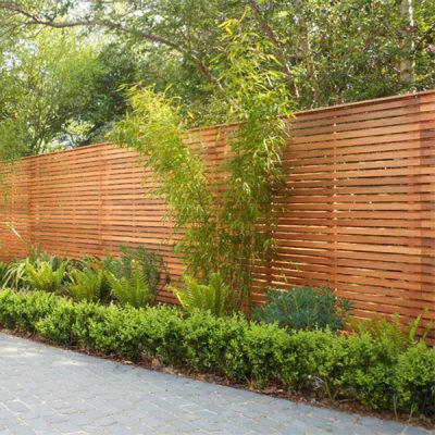 Our slatted bevel edged fence panels are cut with a 45-degree angle and made from cedar wood.