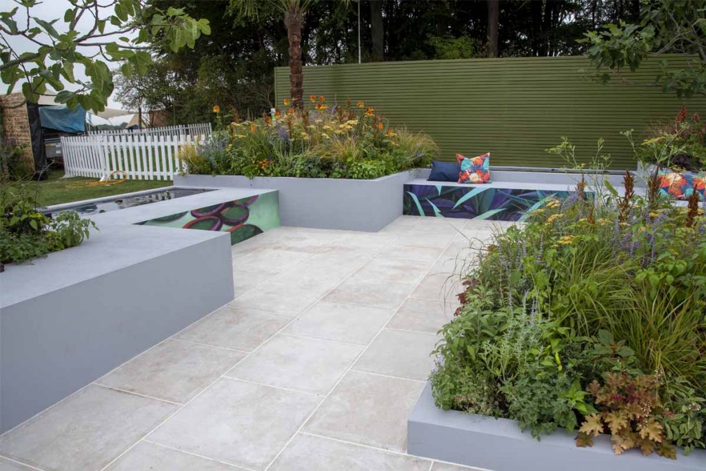 Egyptian Beige Limestone paving, with grey-walled raised beds and ponds in Copme Lime withy Me, RHS Tatton Park 2022.