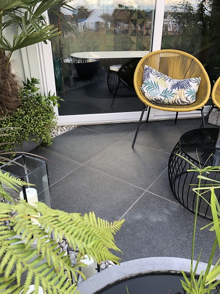 Basalt Porcelain and white pebbles on patio design for RHS Malvern Spring Festival 2019 by Sarah Edwards, built by Design It Landscapes