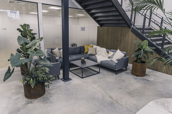 Corten steel pots near garden furniture under staircase in Birmingham showroom