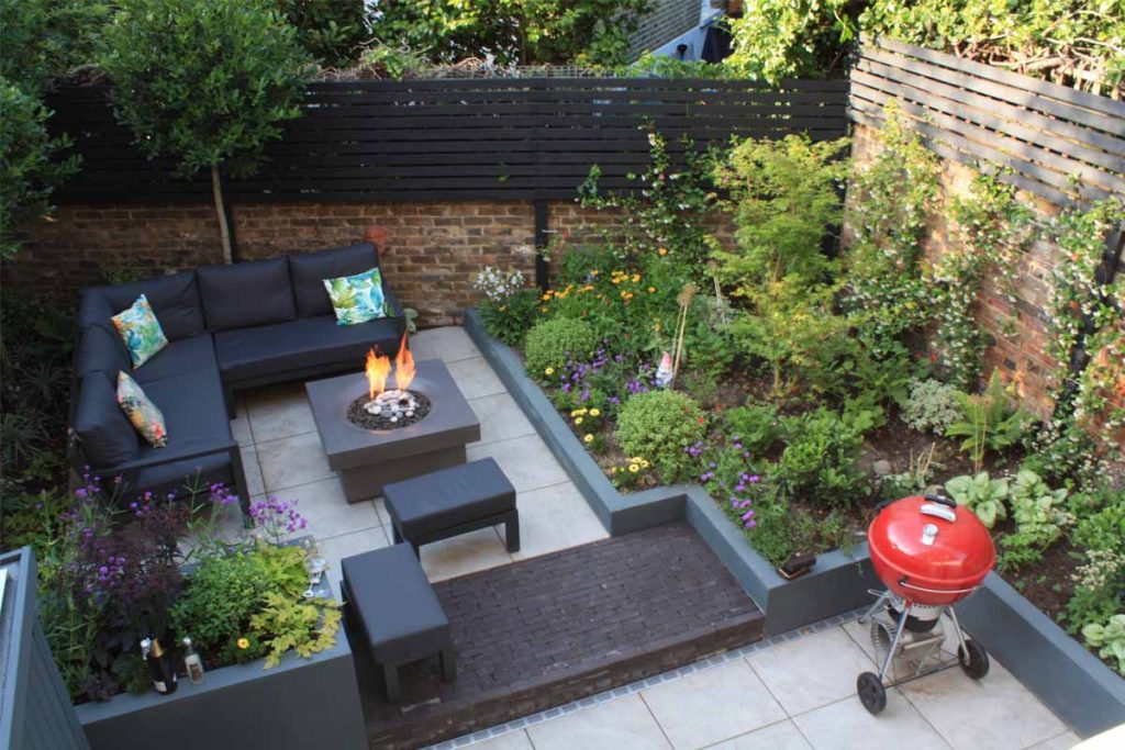 View from above of small rear garden with Silver Grey Porcelain paving, clay pavers and firepit. 
