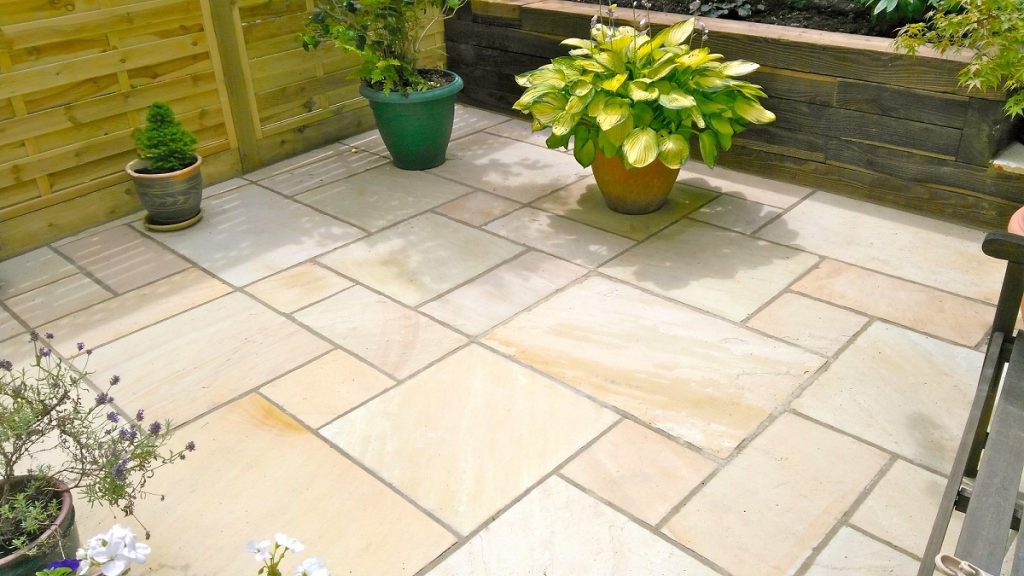 Very clean Mint Indian sandstone patio with hosta in pot. Design by Steve Hooper Landscapes.