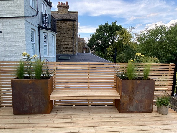 European larch fence, bench and decking with 2 Corten Steel rectangular planters
