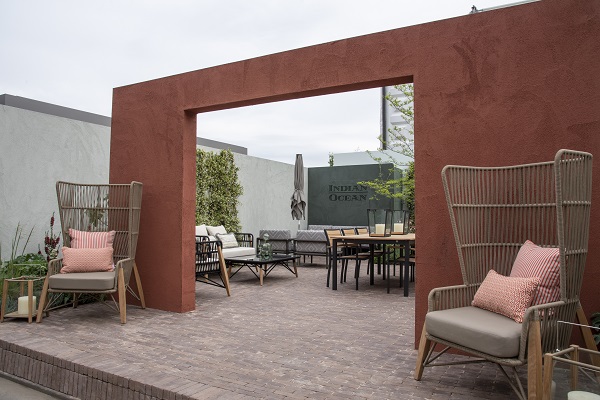 Large Corten steel arch onto Indian Ocean trade stand with Verona clay pavers and outdoor furniture.