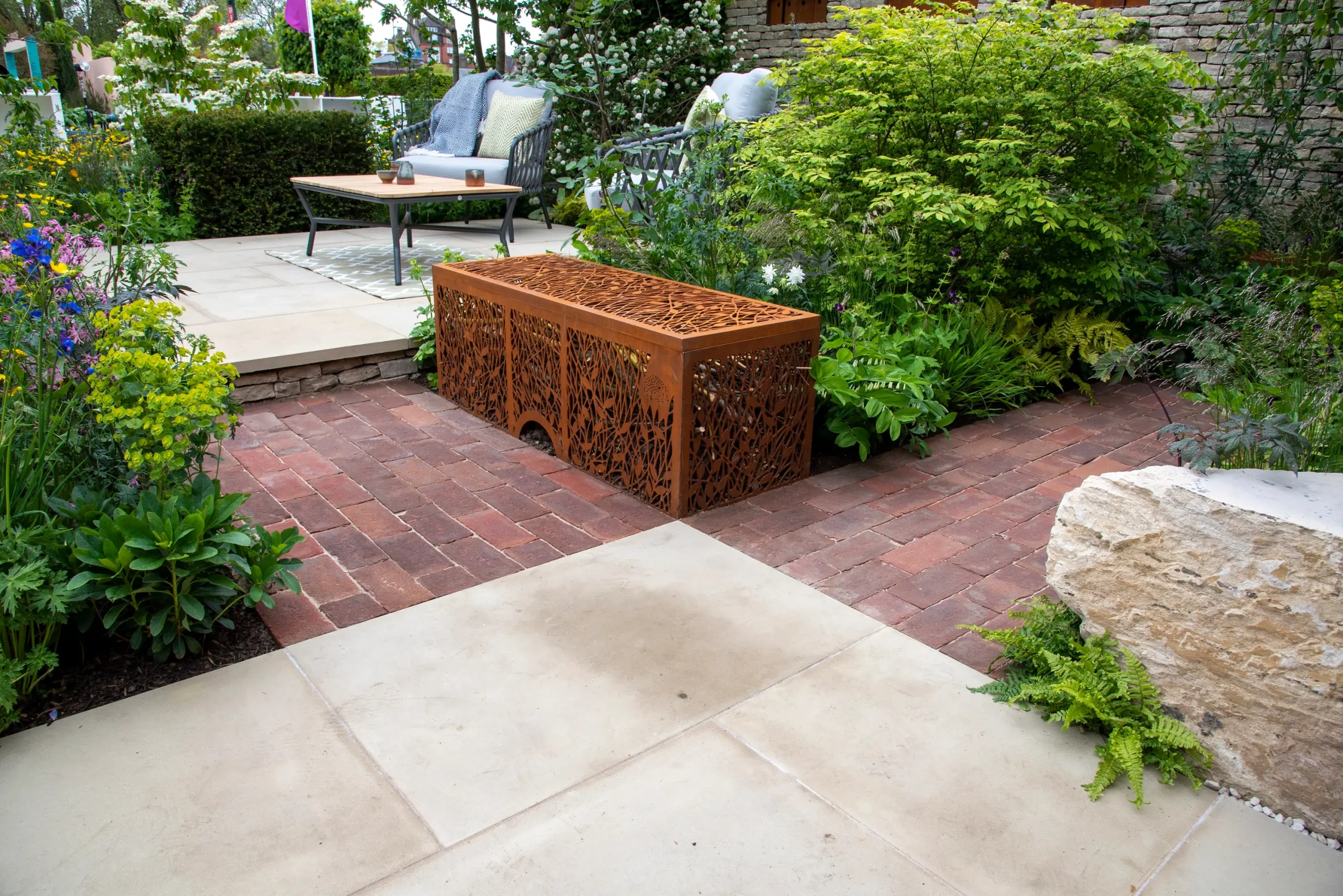 Britannia Buff Yorkstone with Dorset Antique clay pavers, corten steel benches and planting.