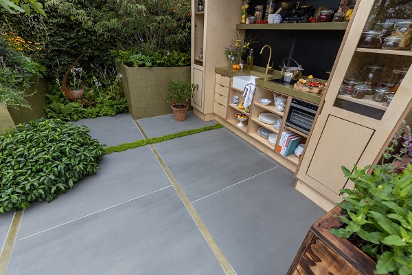 Outdoor food preparation construction with drawers, 2 glass-fronted cupboards and sink by Alan Williams and Landform Consultants.cupboards