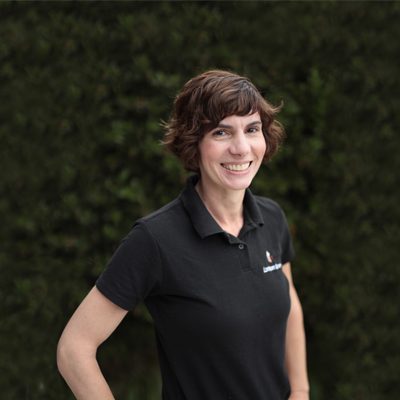 Woman with short dark hair against black background