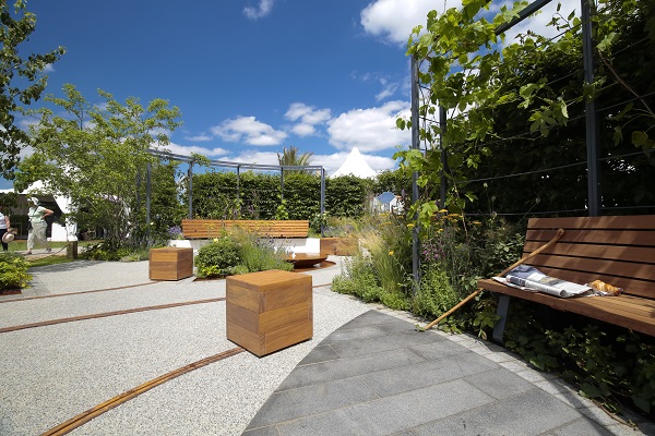 Shaped black granite plank paving contrasts with resin-bound gravel in Crest Nicholson LIVEWELL garden, RHS Hampton Court flower show 2019