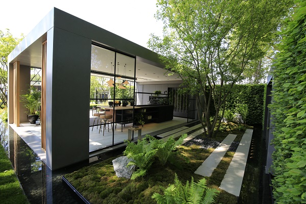 Jura Grey planks lie in mulched bed behind large rectangular garden room at Chelsea flower show 2018.