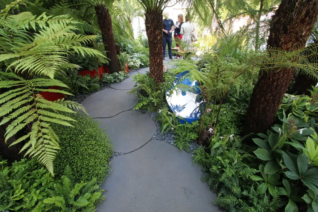 Sinuous path of large bespoke curve-edged sintered stone slabs in Bowel Disease UK Garden, Hampton Court Flower Show 2016