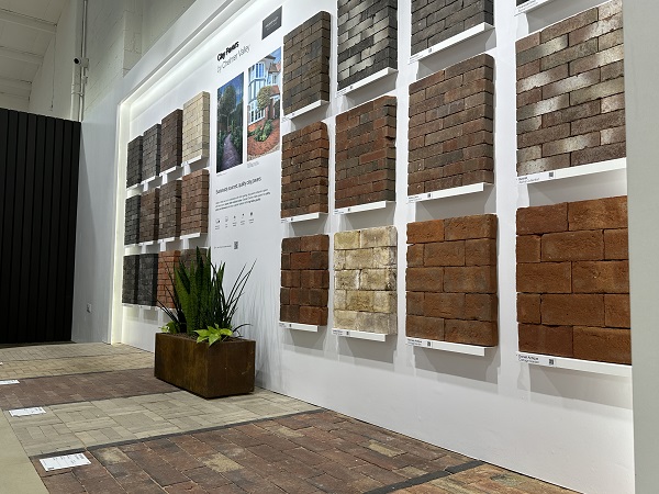 Clay paver display on wall and floor, showing textures and colours in Manchester garden paving showroom.