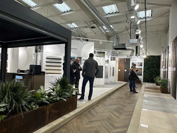 2 pairs of people looking at displays along aisle of Manchester garden paving showroom.