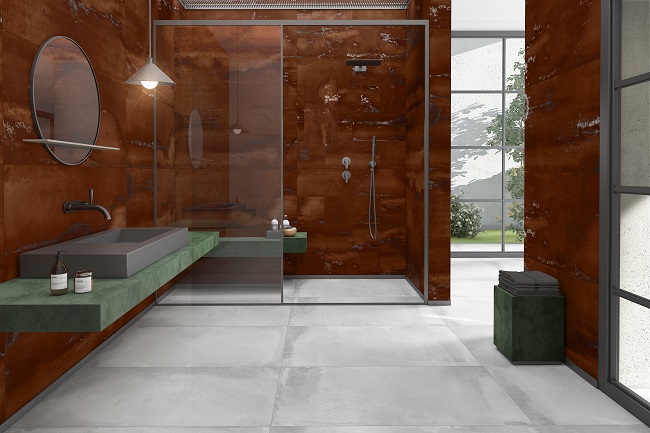 Bathroom with grey tile flooring and large glass-fronted shower with walls of Siena Copper vitrified porcelain large indoor tiles.
