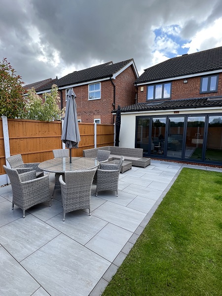 Kandla Grey porcelain patio of 900x600mm slabs with Steel Grey edging setts.