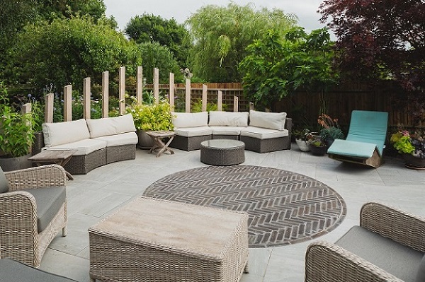 Seats round edge of circular paved area of Kandla Grey porcelain with central circle of Moderna clay pavers. 