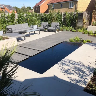 Charcoal DesignBoard creates bridge along long side of rectangular pond, next to Florence Grey porcelain paved seating area.