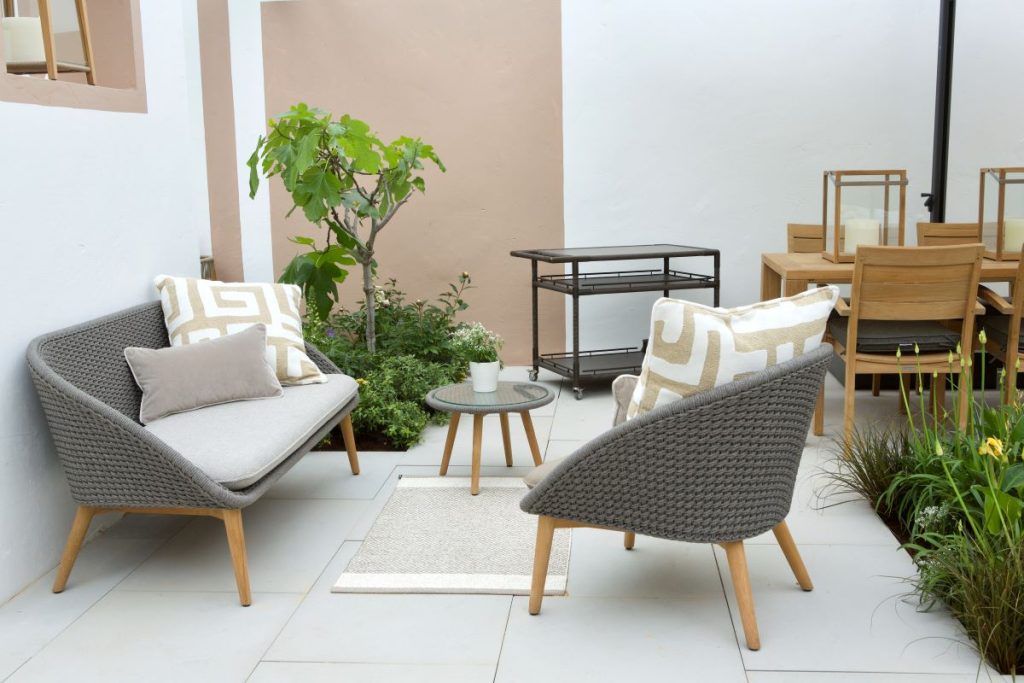 Dove Grey sawn sandstone paving under outdoor furniture on Indian Ocean stand, Chelsea Flower Show 2025