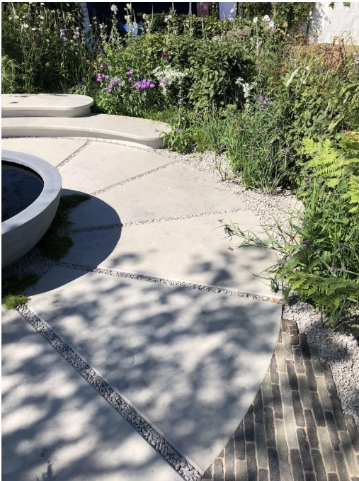 South West Water Garden with stone bowl in centre of bespoke paved circle, Hampton Court Flower Show 2018