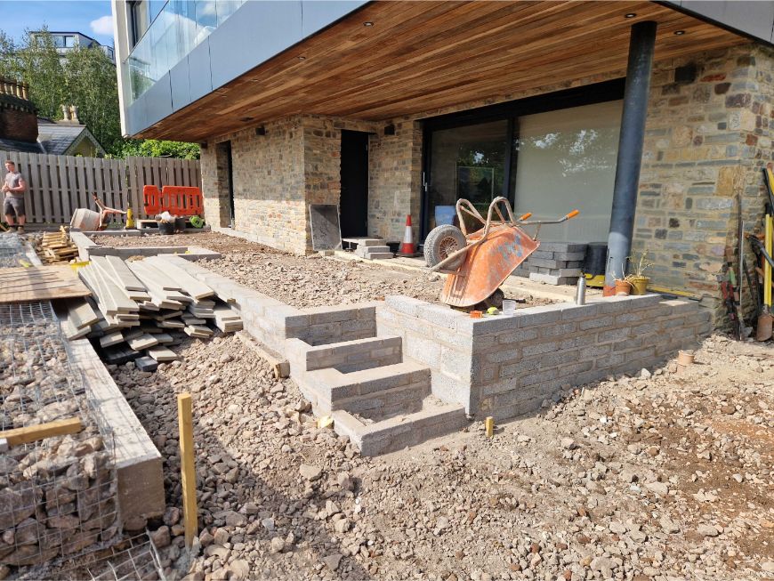 Sub base being constructed outside modern house.