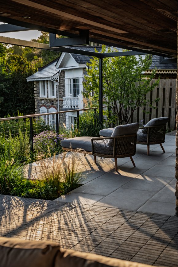 View across terrace of Florence Grey porcelain paving and clay pavers.