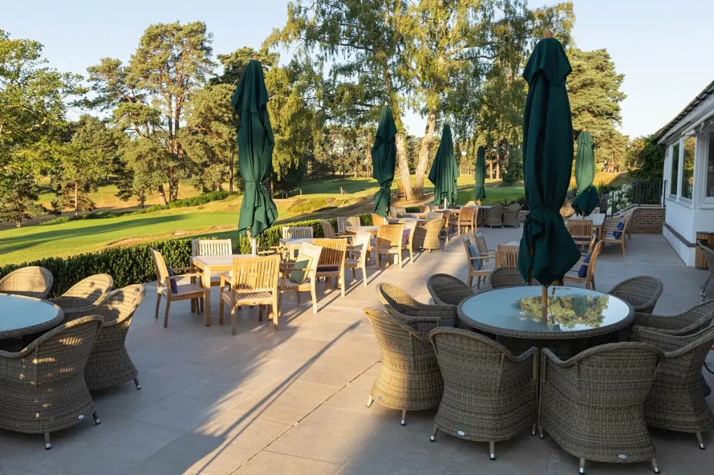 Golf club terrace in Egyptian Beige limestone with round dining tables