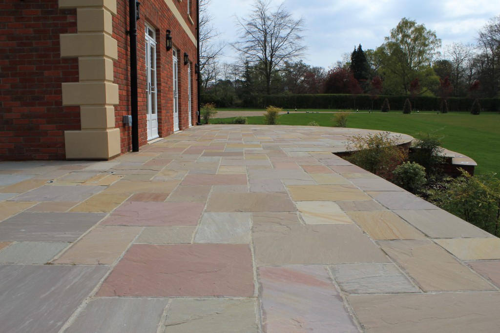 Large patio of Raj Green sandstone, breaking up the area with different colour. 